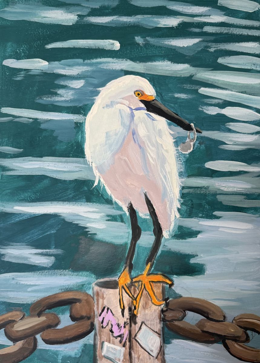 A white seabird is standing on top of a pole connecting chains together. The pole has some graffiti and stickers. The birdd has a metal pull-tab stuck on its beak.