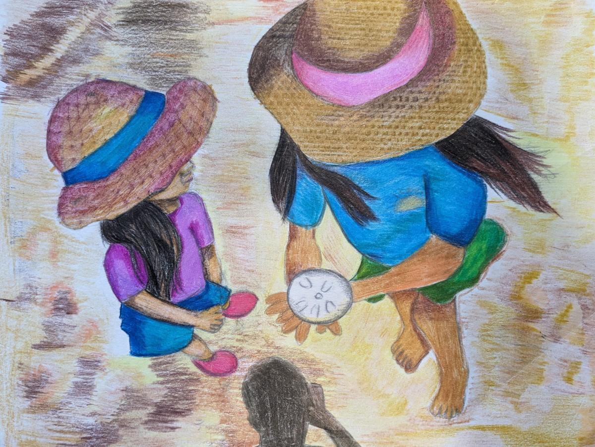 Two children in sun hats are seen from above as they stand on the beach holding a sand dollar shell.