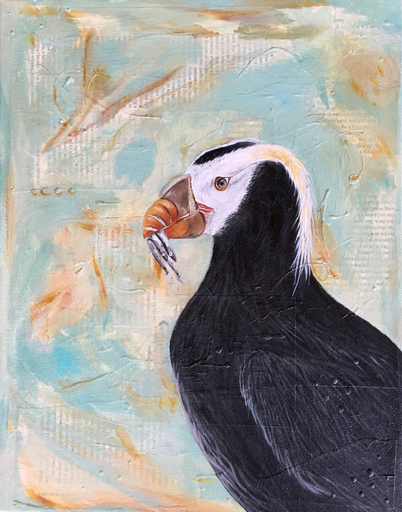 A puffin in profile hold fish in its beak. The background is painted over words, hard to make out.