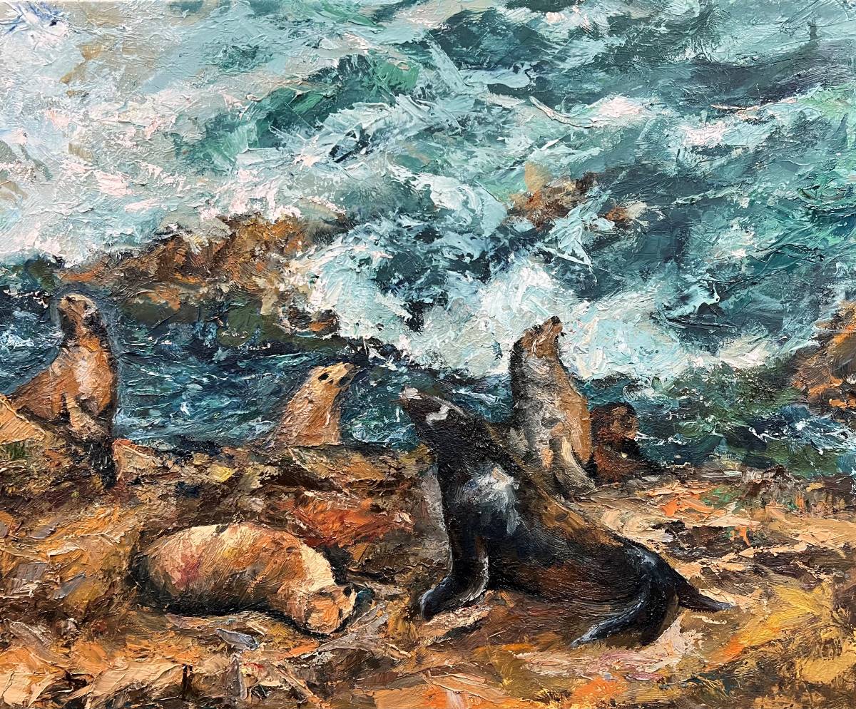 Sea lions sit on rocks as waves crash.