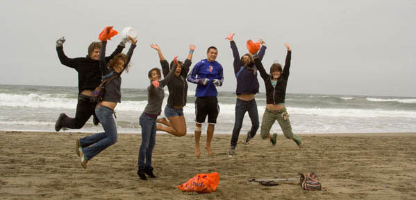 Photo of people on the beach jumping for joy