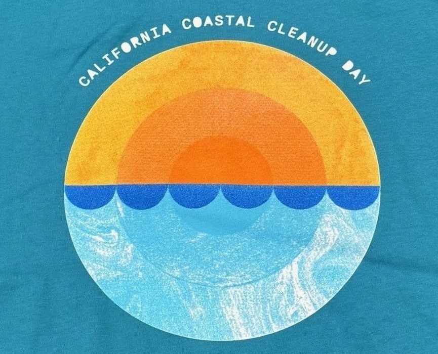 The front of the 2024 Coastal Cleanup Day Shirt with round image of sun setting on the ocean, with teal background