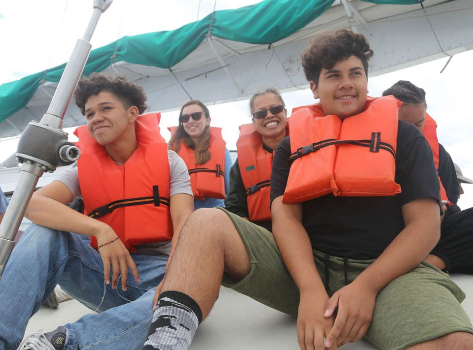 Smiling students on boat