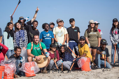 Smiling kids on the beach after a beach cleanup