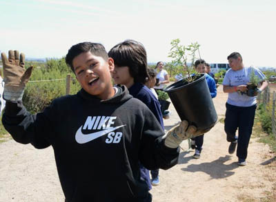 Kids carrying plants